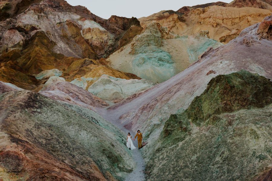couple standing in colorful desert mountains