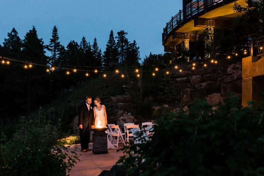 A bride and groom enjoy an outdoor firepit in the evening after their eastern Washington elopement at Swiftwater Cellars
