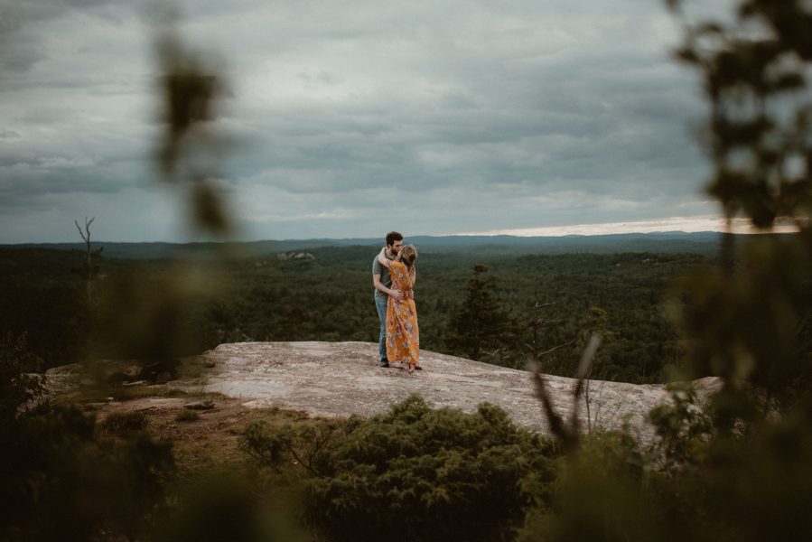 Couple embracing on top of Hogback Mountain in Marquette Michigan