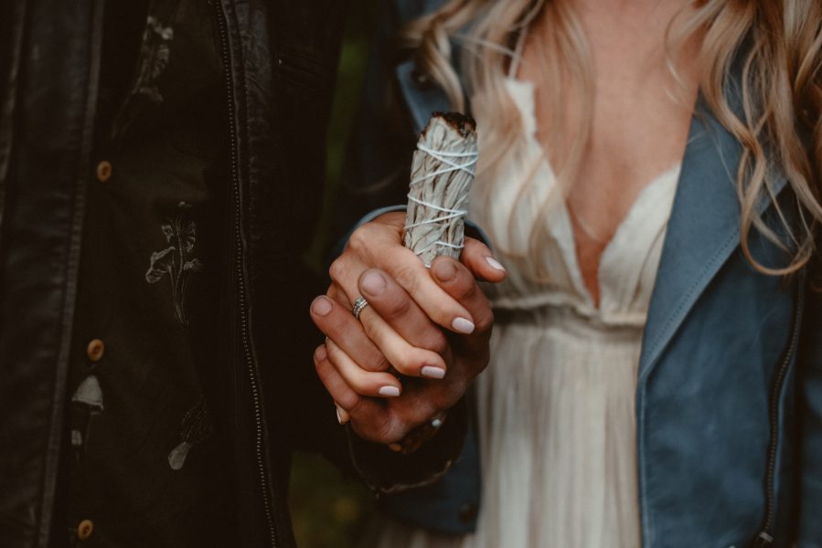 Couple holding sage bundle during engagement session in Michigan