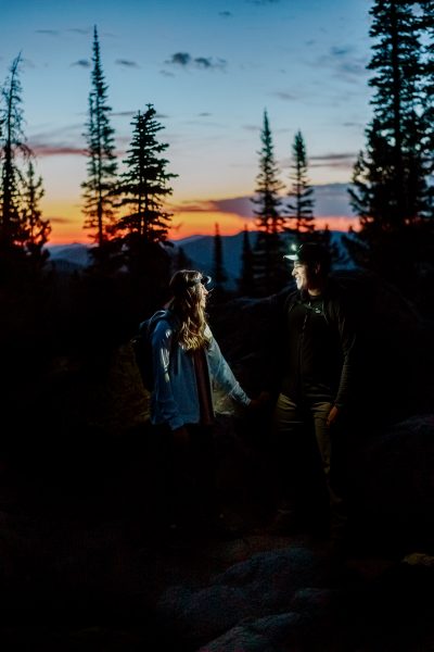 Couple hiking before sunrise in Colorado.