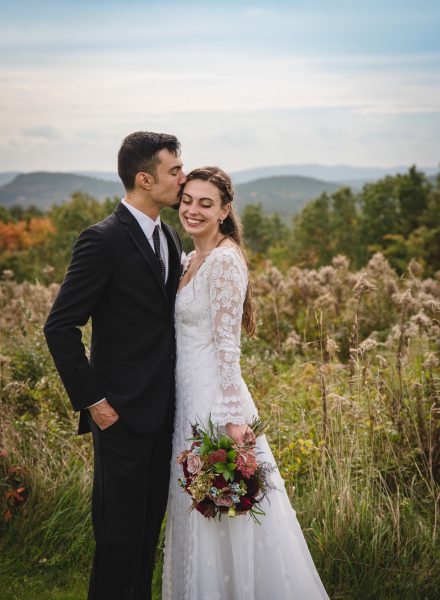 elopement couple hugging in meadow