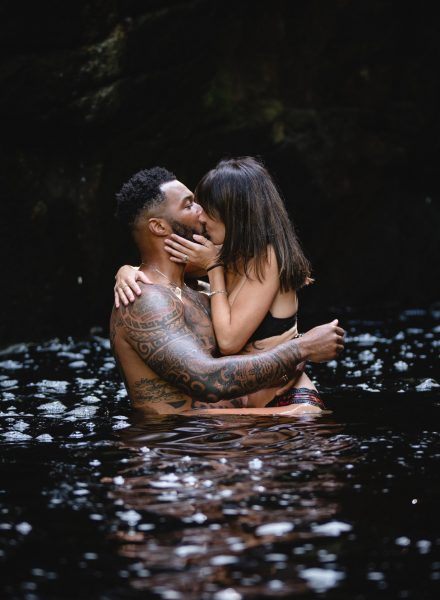 couple swimming and kissing in the water