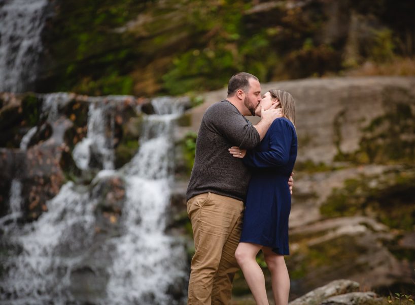 couple kissing in front of waterfalls in Connecticut