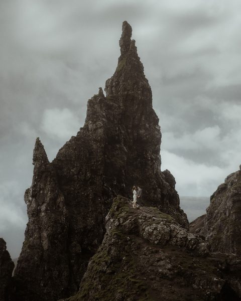 isle of skye elopement at old man of store with couple kissing at the pinnacle