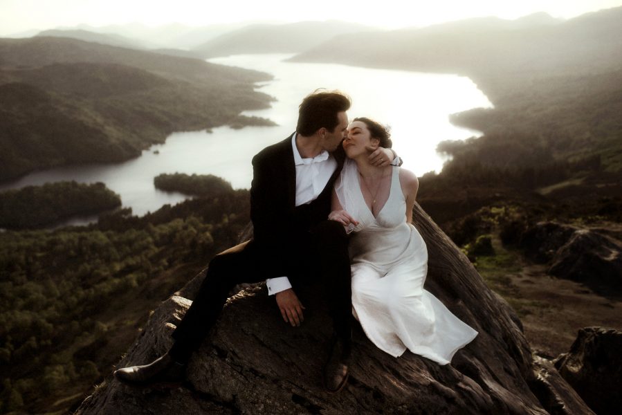 scotland elopement photographer with couple on the summit of A Ascottish mountain at sunset
