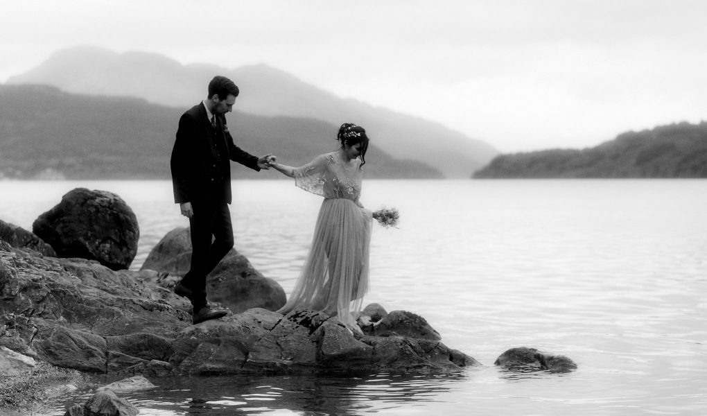 a couple walking beside Loch Lomond after their elope in Scotland