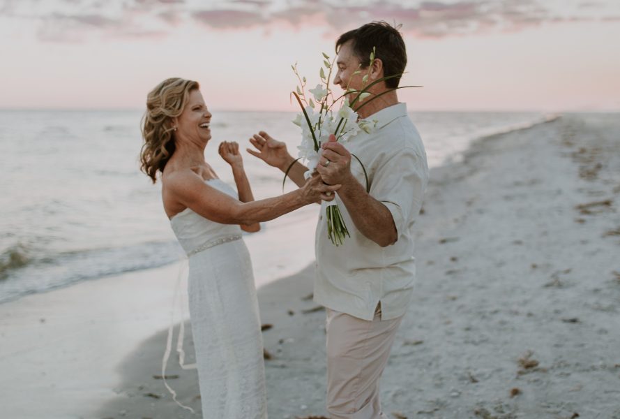 older couple dancing on a beach in Florida