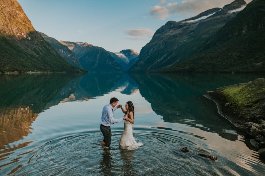 Bride and groom in a glacier lake Lovatnet in Loen Norway