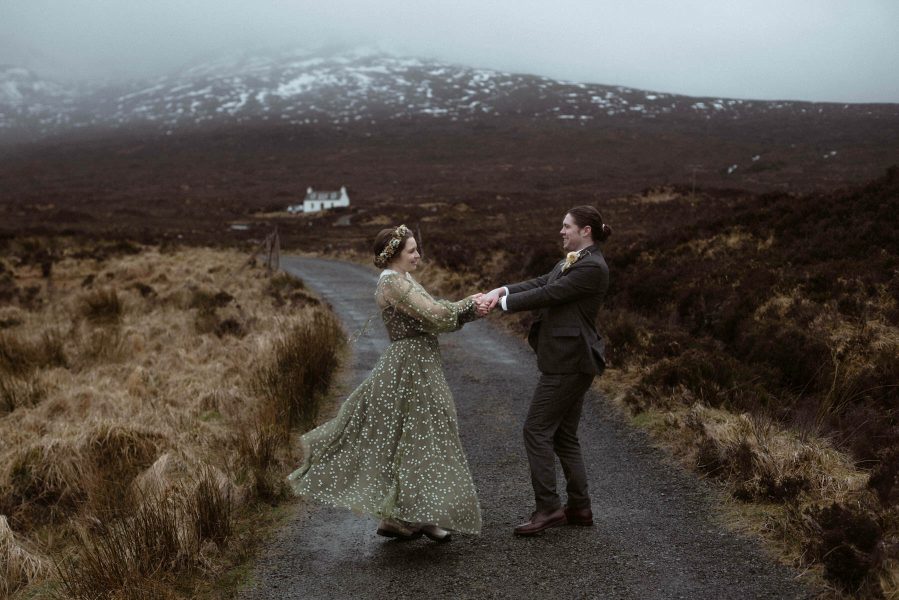Bride and groom dance in the mountains on the Isle of Skye