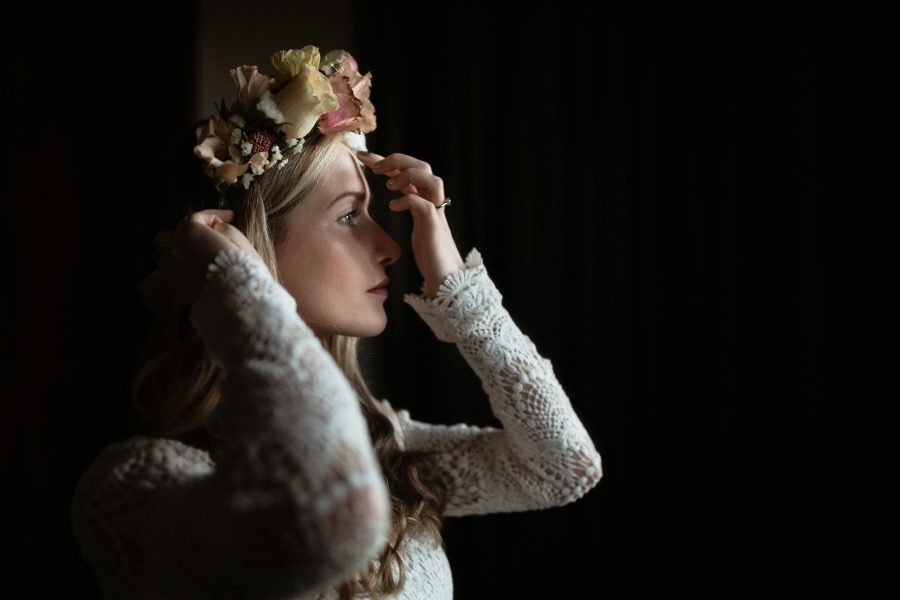 Bride putting the finishing touches to her flower crown at a Scottish elopement wedding