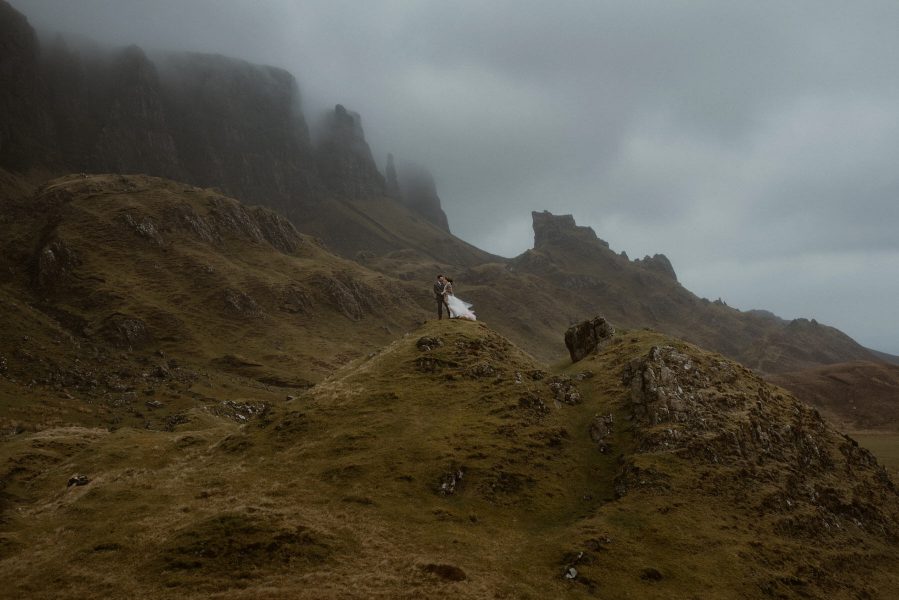Bride and groom with mountain backdrop in Scotland