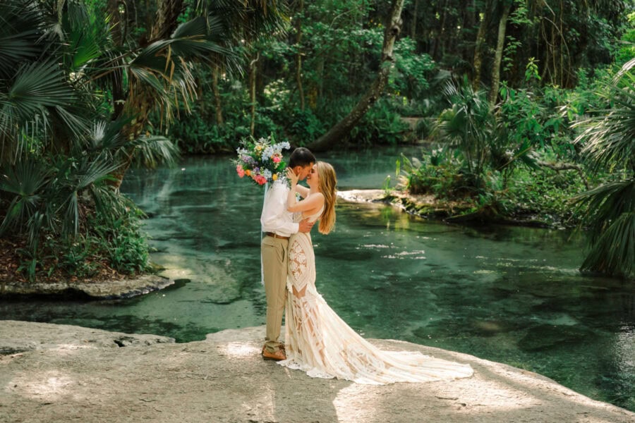 couple kisses at Florida spring after saying I do
