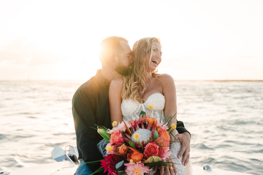 couple sits on boat in Florida during elopement