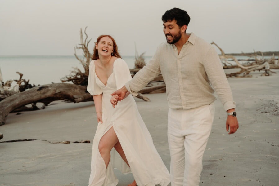 bride and groom runs on beach