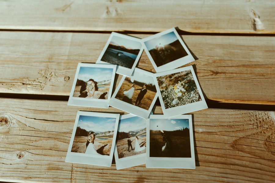 polaroids on a picnic table of happy couple on their wedding day