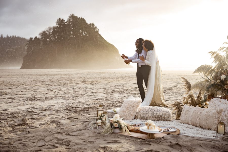 couple-pops-champagne-during-neskowin-beach-adventure-elopement-at-sunset