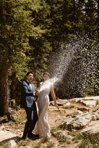 a couple spraying champagne to celebrate their wedding!