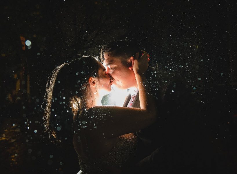 elopement couple kissing in the rain at night