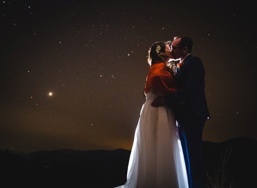 bride and groom kissing under a starry sky for their White Mountains, NH elopement