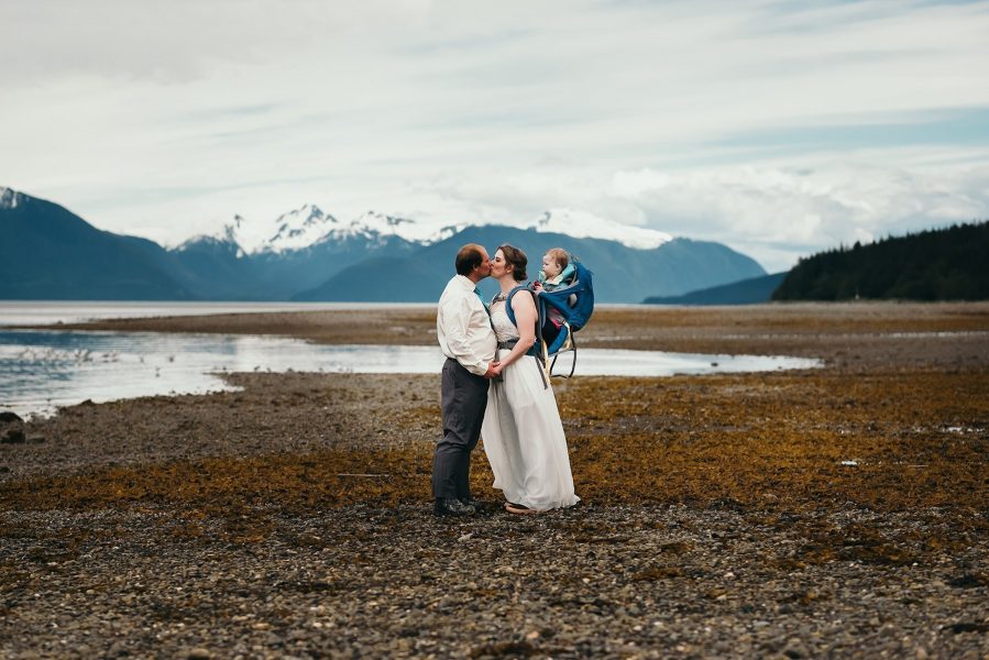 babywearing bride on alaska beach
