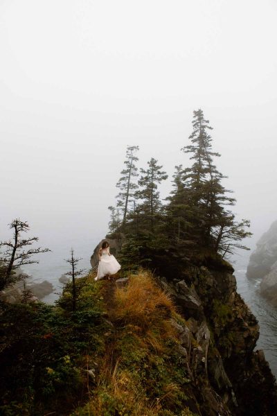 Bride walking along the coast of maine
