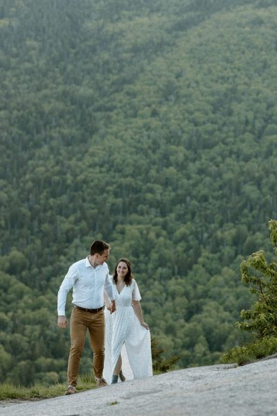couple walking and holding hands in wedding attire