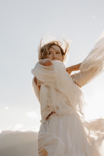 bride at sunset in glacier national park in white flowy dress