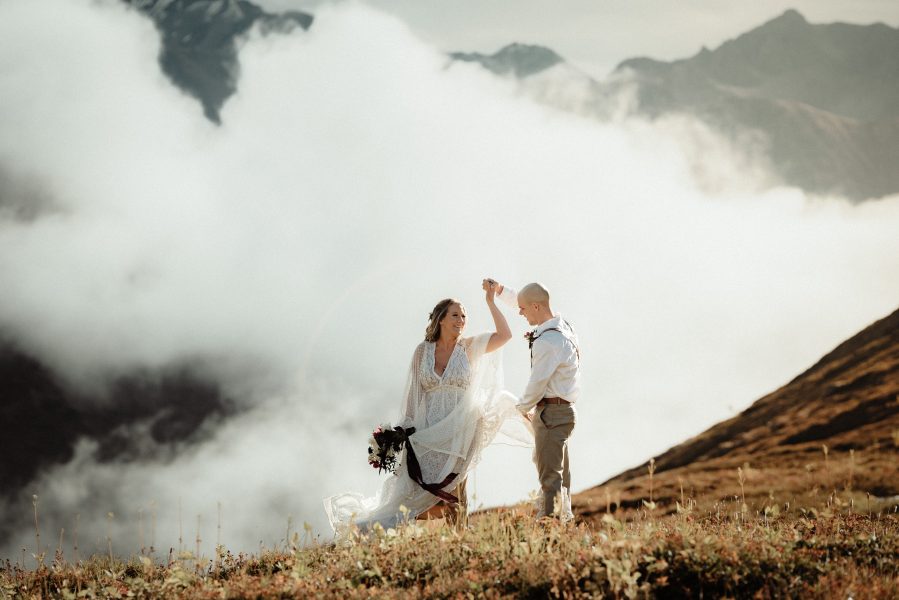 bride and groom dancing in the clouds in Hatcher Pass Alaska