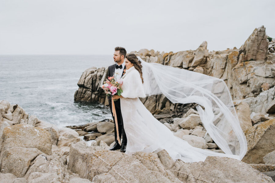 elopement couple stand on cliffs at lover's point in monterey, CA