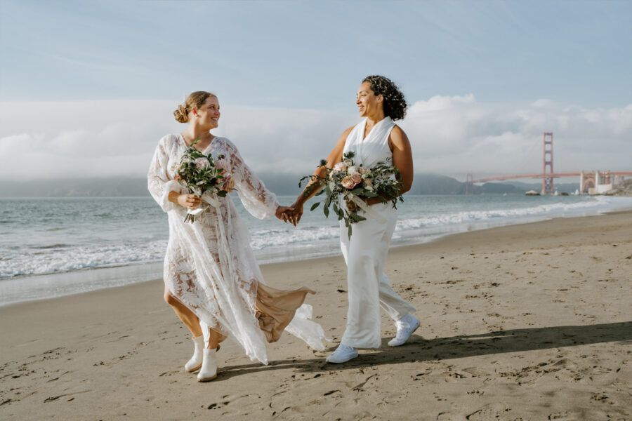 adventure elopement couple taking a walk on Baker Beach in San Francisco