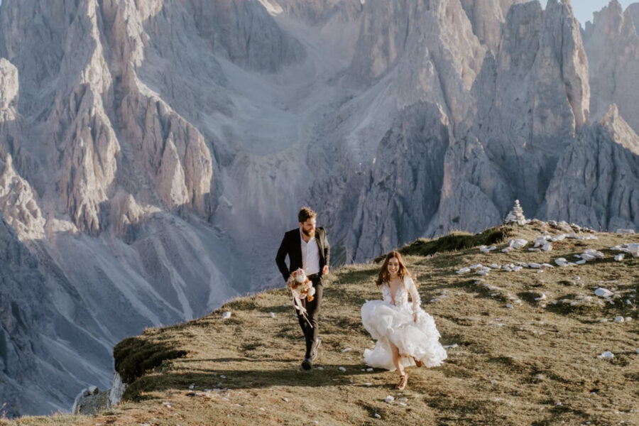 adventure elopement couple running in the dolomites