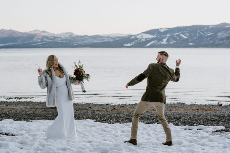 elopement couple in Tahoe throwing snowballs