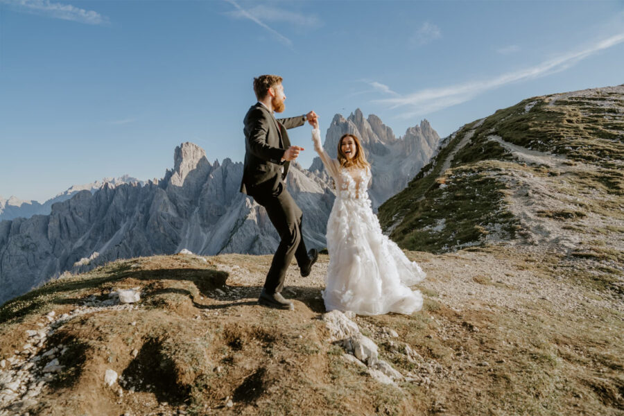 couple dancing in the dolomites, Italy on their wedding day