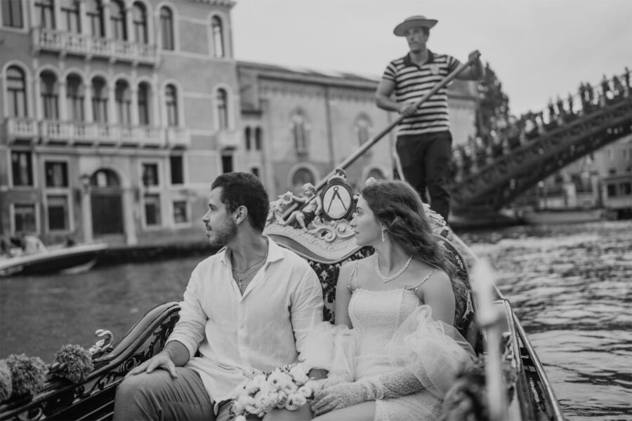 Couple sharing a Gondola ride through the canals of venice on their elopement