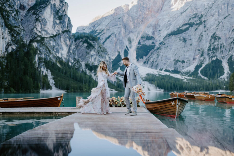 Couple dancing after vows at Lago Di Braies, Dolomites, Italy