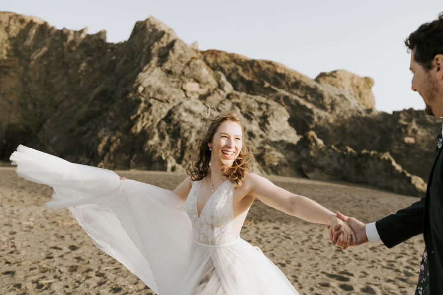 bride and groom dancing on beach