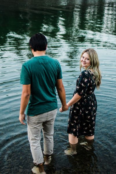 Couple wades through water at Pactola Lake in Black Hills National Forest