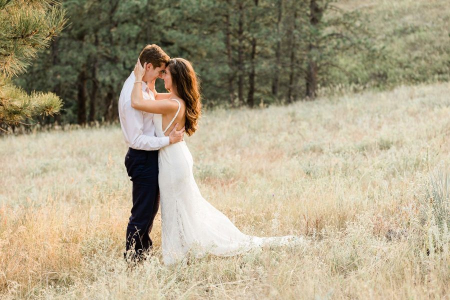 Couple embraces during sunset photos at intimate backyard wedding in Rapid City, SD