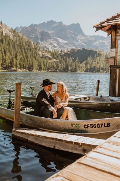 Elopement portrait at Sardine Lake. Couple in wedding attire in boat.