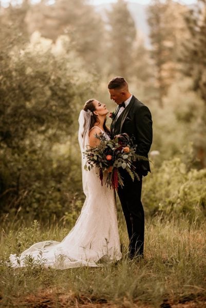 Sunset elopement portrait in Lake Tahoe. Couple in wedding attire in forest.