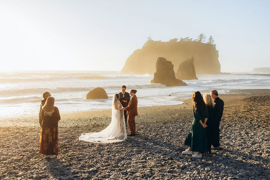 Small group gathered for an intimate elopement ceremony at Ruby Beach in Olympic National Park at sunset
