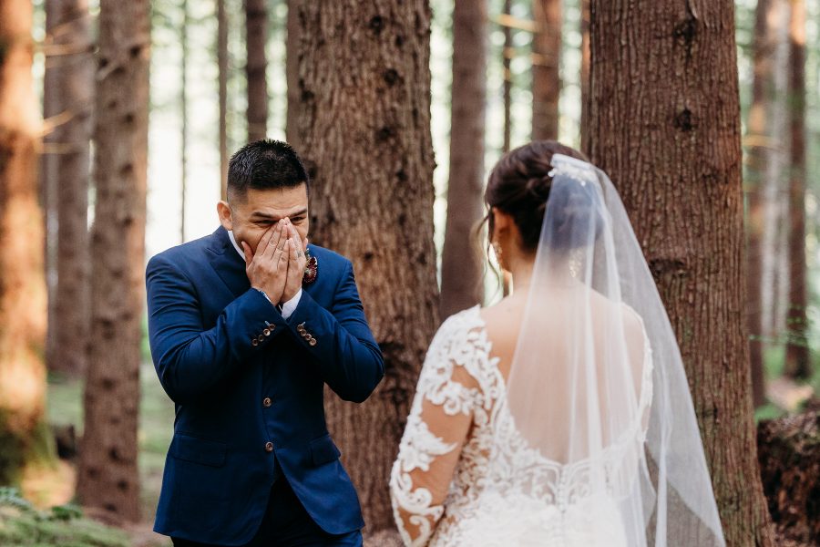 First look of a groom seeing his bride at Emerald Forest