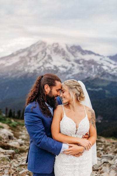 Newlyweds embracing at mount rainier national park