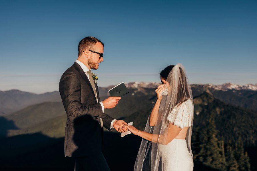 Couple saying vows on a sunny mountain top