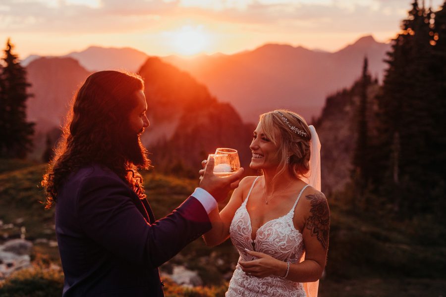 Bride and groom toasting during sunset at Mount Rainier National Park