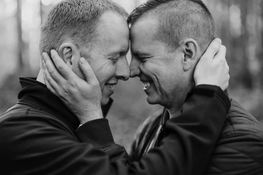 Engaged men embracing