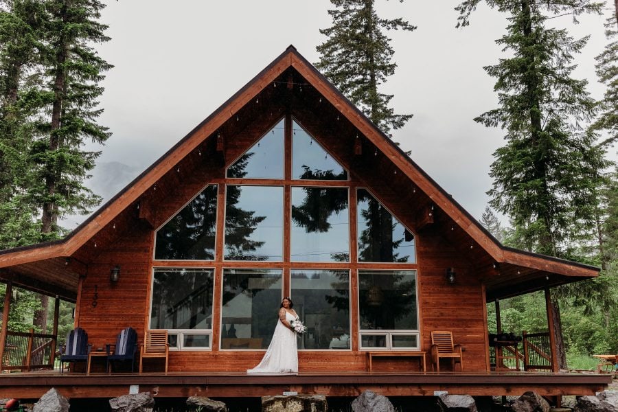 Bride standing in front of airbnb cabin in Packwood