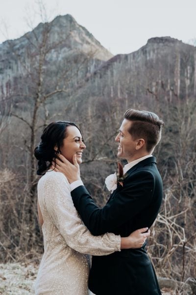 Bride and Groom embrace as they overlook the Chimney Tops in the Smoky Mountains National Park