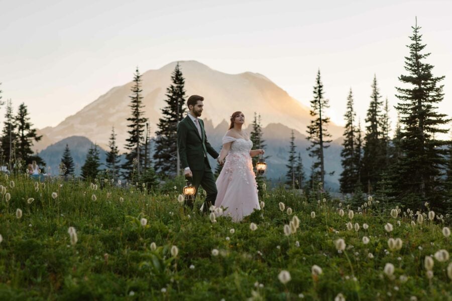 Couple walking through wildflowers at Mount Rainier Elopement